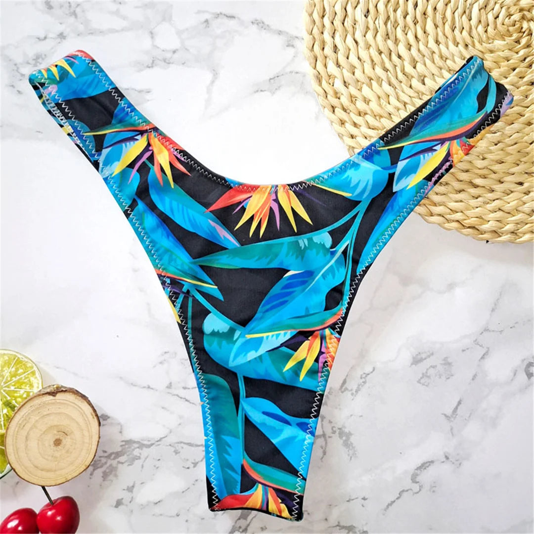 Stylish printed bikini bottoms in vibrant colors, Brazilian tanga cut swimwear for women made with nylon and spandex. Perfect for lounging by the beach or swimming, wire free support and low waist design with a true to size fit. Part of a bikinis set without pad, resonating beach style in leaves print. Female swimwear for ages 18 to 35 and adult, available in stock and comes with free shipping offer.