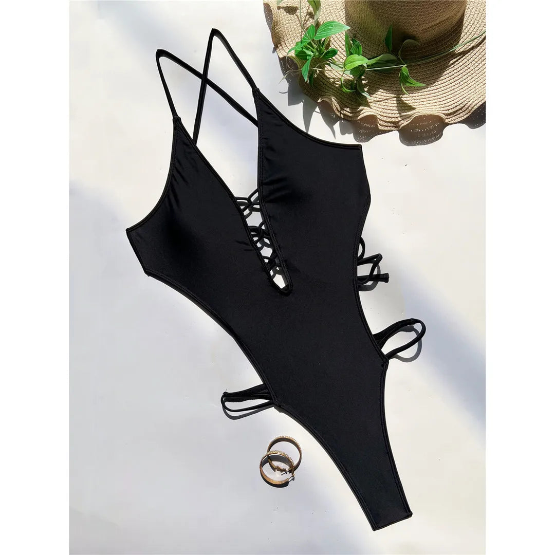 Deep V Neck Cross Back One Piece Swimsuit, a statement piece available in sizes S to XL. Made of Nylon and Spandex, this one-piece swimsuit or monokini is solid black. Features a high leg cut and support-free design, perfect for modern sophistication. A daring design that combines comfort and elegance, standing out at any waterside occasion.