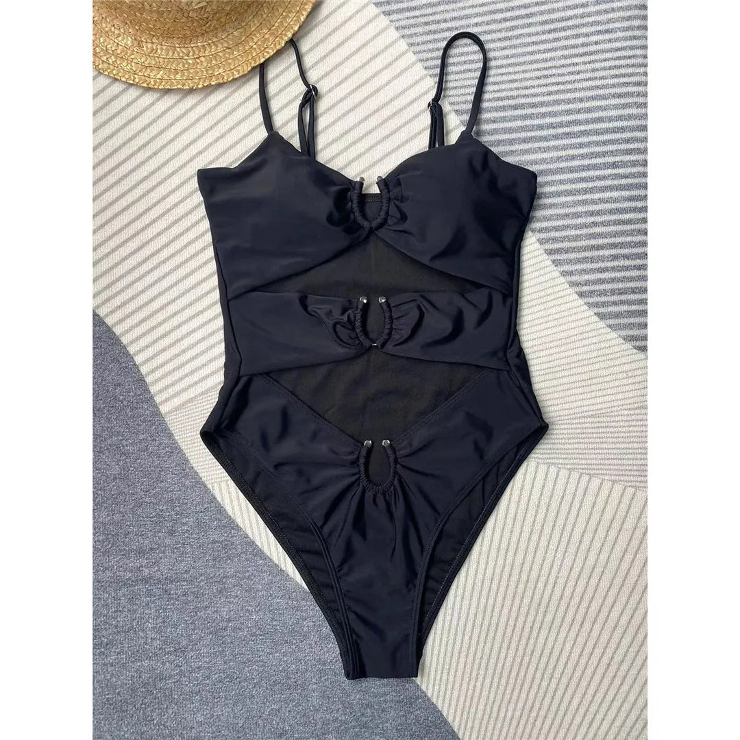 Turn heads in our Tummy Cut Out Metal Rings One Piece Swimsuit available in Black and White. This striking monokini, made from nylon and spandex, is designed with bold metal ring details and a high leg cut to accentuate your curves. Fitting true to size, this sleek solid color swimsuit with wire free and padded support is sure to be a showstopper at any beach or poolside event.