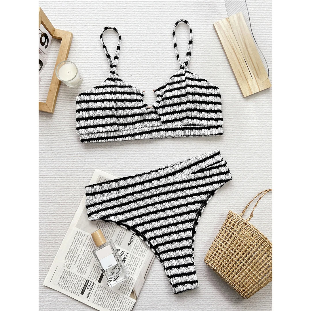 Black and white striped cut-out bikini set, high-waist design, polyester spandex blend, wire-free support, women's two-piece swimwear, chic and flattering silhouette.