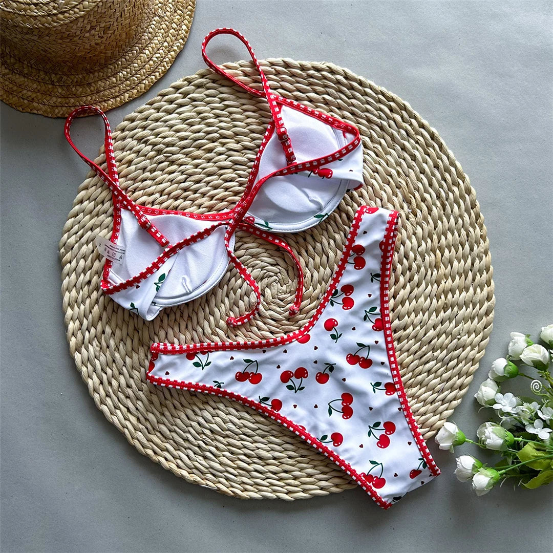 Cherry Printed Underwired Brazilian Bikini set with playful cherry print, Polyester Spandex material, underwired top for support, low waist design for women, fun and vibrant style.