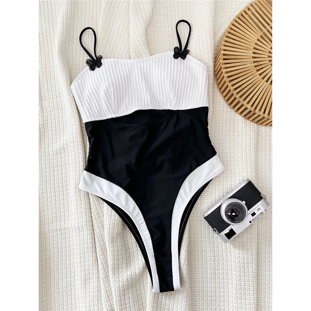 Splicing cut-out ribbed one-piece swimsuit, high-leg padded design, adjustable triangle top, polyester spandex blend, monochrome patchwork pattern, women's swimwear.