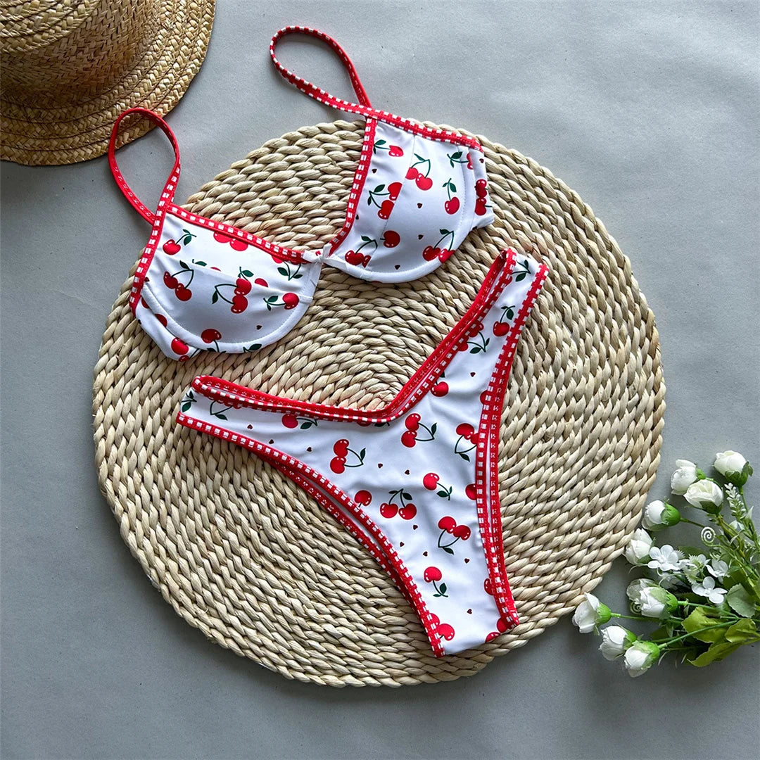 Cherry Printed Underwired Brazilian Bikini set with playful cherry print, Polyester Spandex material, underwired top for support, low waist design for women, fun and vibrant style.