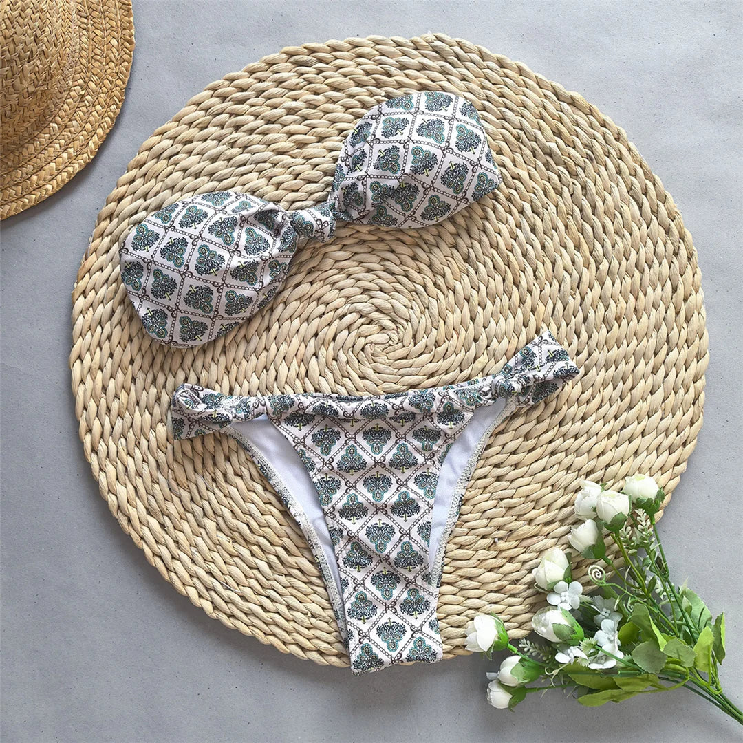 Printed bandeau knotted bikini set, high-leg design, polyester spandex blend, wire-free support, low waist, women's two-piece swimwear, trendy design with playful print.