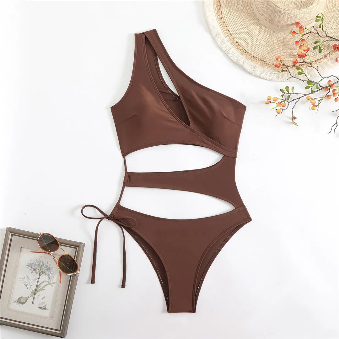 Cut out asymmetric one shoulder one piece swimsuit in red, black, and coffee with high leg design.